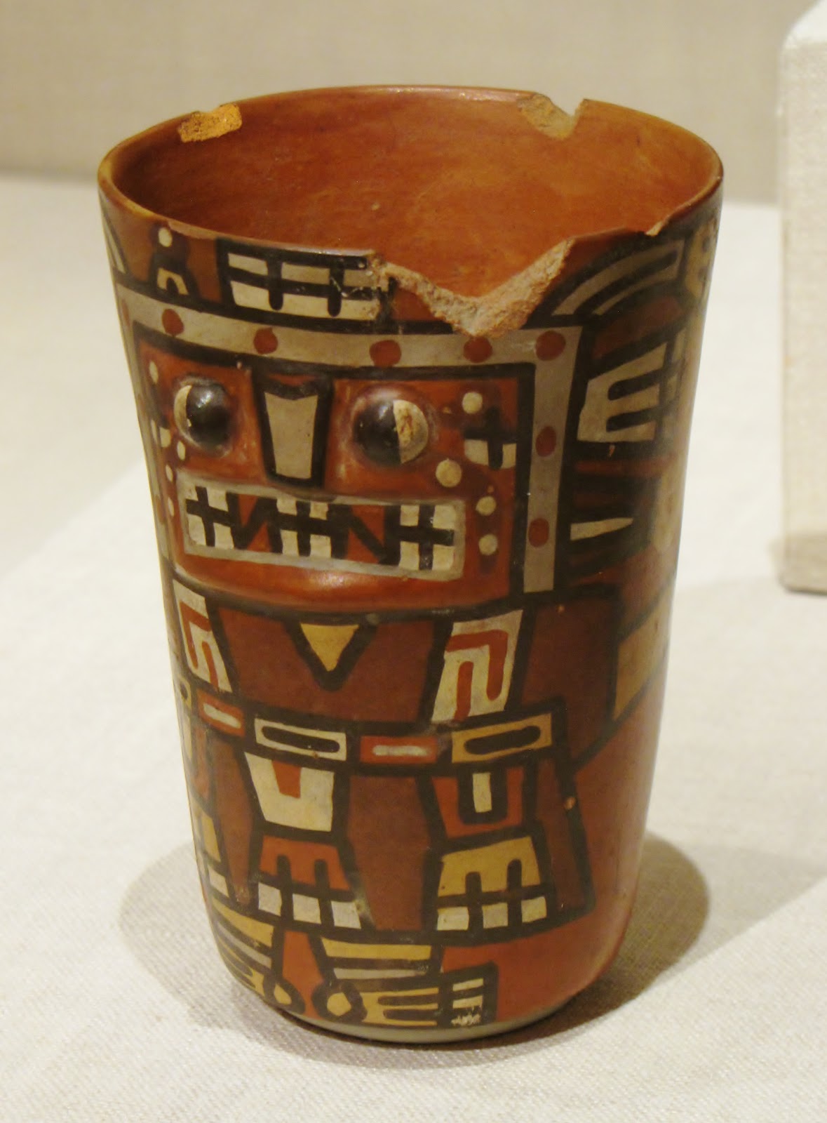 Drinking Cup (Kero) with an Abstracted Masked Figure, ceramic and pigment, 600/1000 CE, Tiwanaku-Wari, Bolivia or Peru